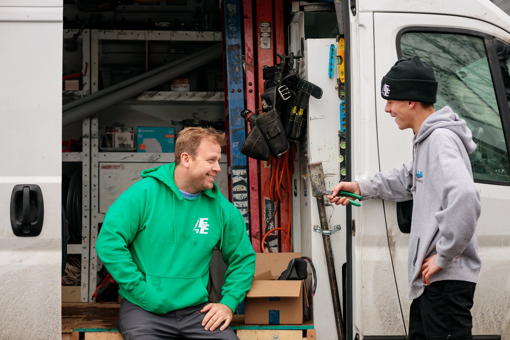 electrician and client discussing near van